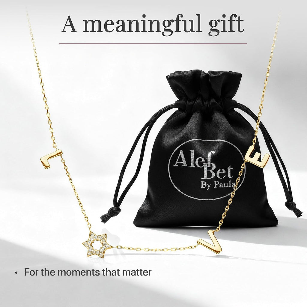 LOVE WITH A JEWISH STAR IN GOLD: The word LOVE is spelled out in warm yellow gold script letter charms where the letter O is replaced by a Star of David set with cubic zirconia, a clever and beautiful