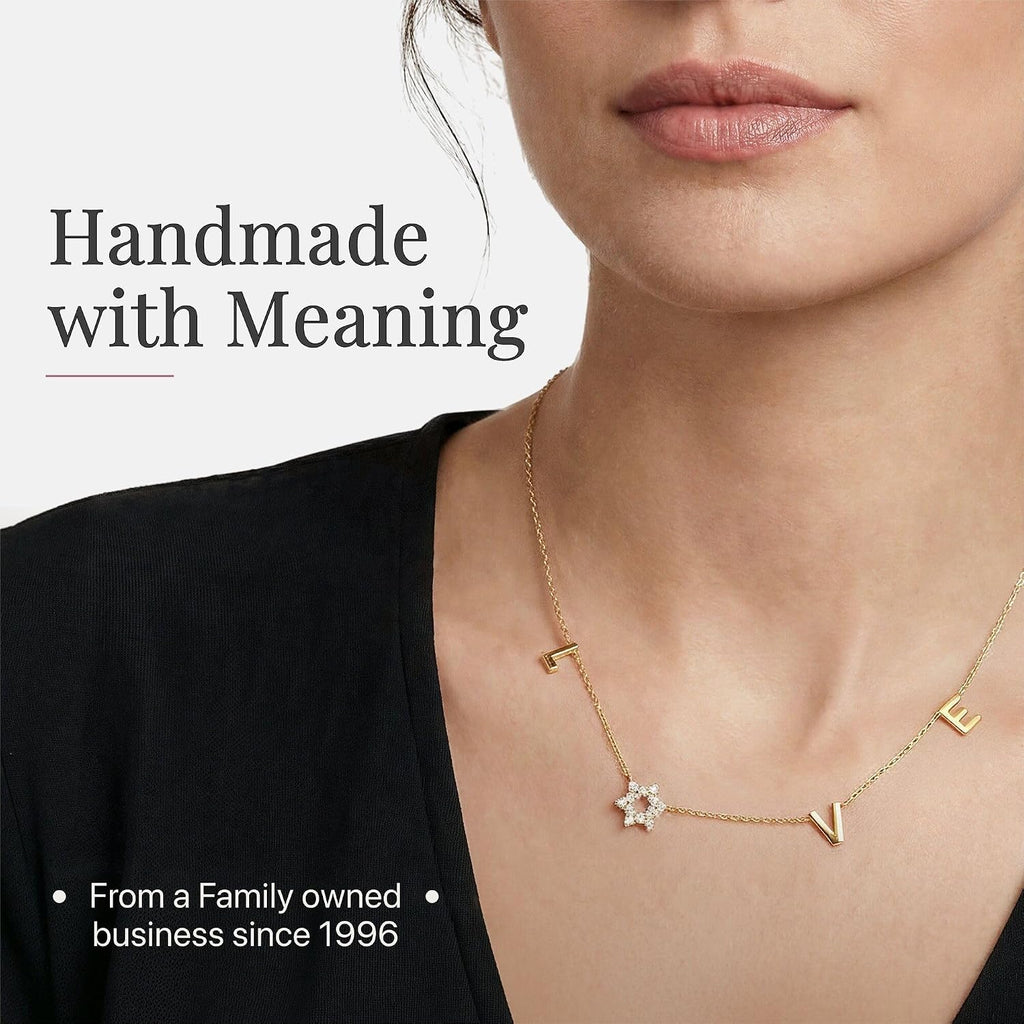 LOVE WITH A JEWISH STAR IN GOLD: The word LOVE is spelled out in warm yellow gold script letter charms where the letter O is replaced by a Star of David set with cubic zirconia, a clever and beautiful