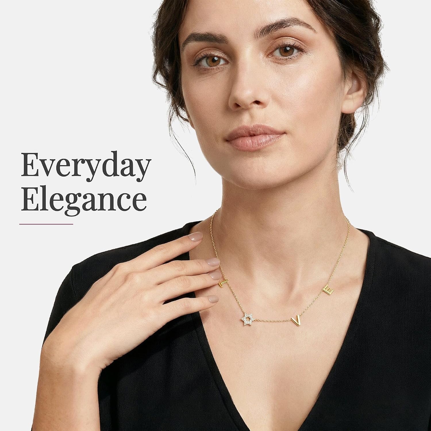 LOVE WITH A JEWISH STAR IN GOLD: The word LOVE is spelled out in warm yellow gold script letter charms where the letter O is replaced by a Star of David set with cubic zirconia, a clever and beautiful